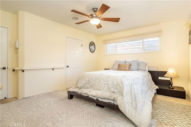 bedroom featuring light carpet and ceiling fan