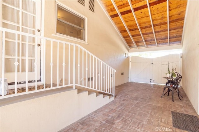 interior space featuring brick floor and wood ceiling