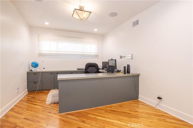 home office with light wood finished floors, baseboards, visible vents, and recessed lighting