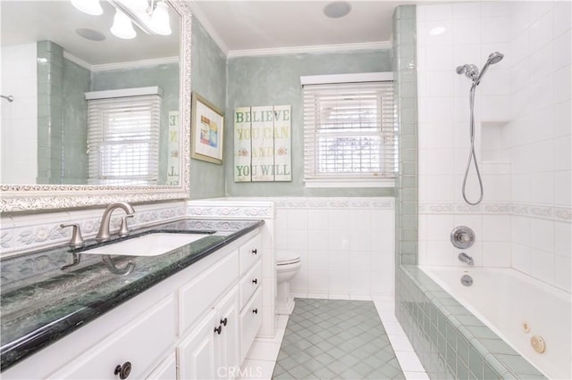 full bath featuring crown molding, tile walls, a combined bath / shower with jetted tub, toilet, and vanity