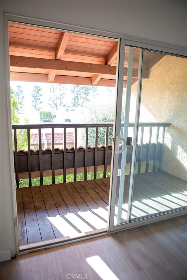 entryway featuring beamed ceiling and wood finished floors