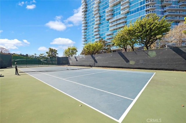 view of tennis court with fence