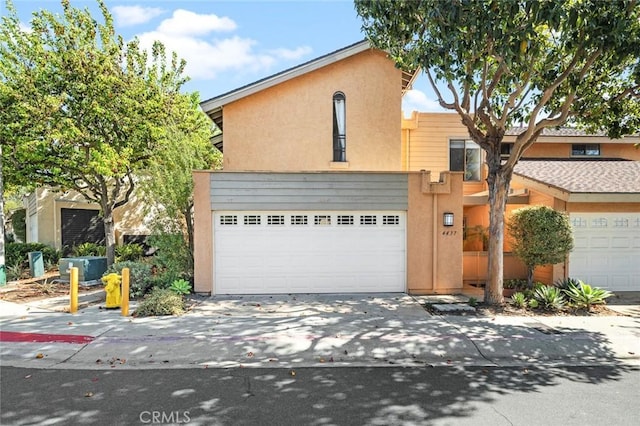 view of front facade featuring concrete driveway and stucco siding