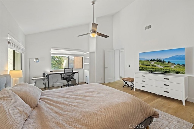 bedroom with vaulted ceiling, ceiling fan, wood finished floors, and visible vents