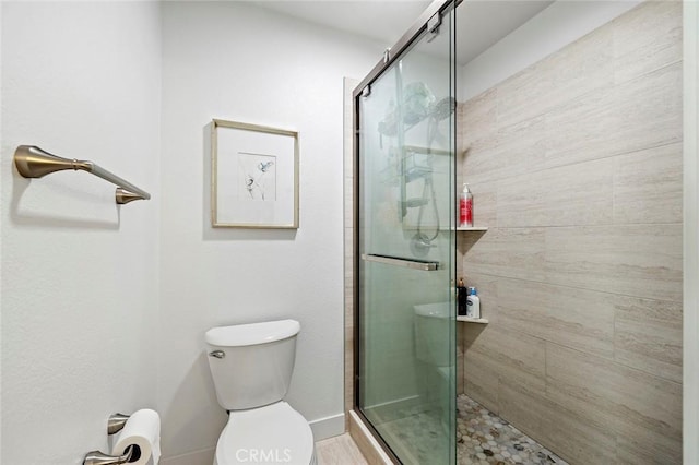 bathroom with toilet and a shower stall