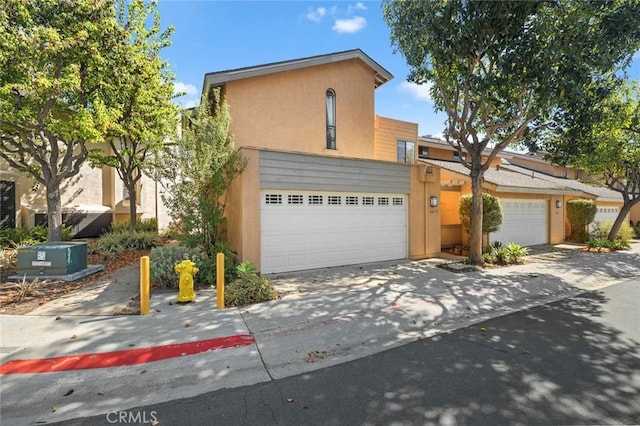 view of front of property featuring concrete driveway and stucco siding