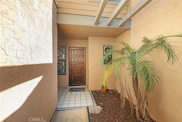 entrance to property with stucco siding