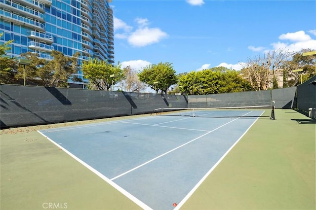 view of tennis court featuring fence