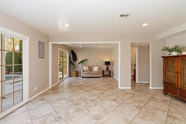 unfurnished room with recessed lighting, visible vents, and baseboards