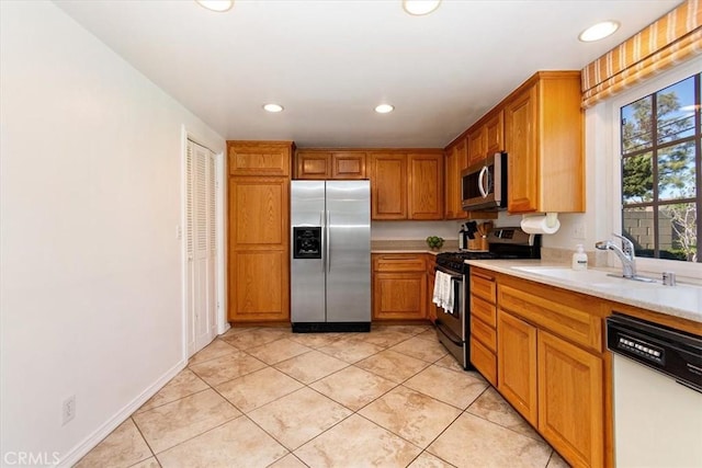 kitchen with light tile patterned floors, recessed lighting, stainless steel appliances, a sink, and light countertops