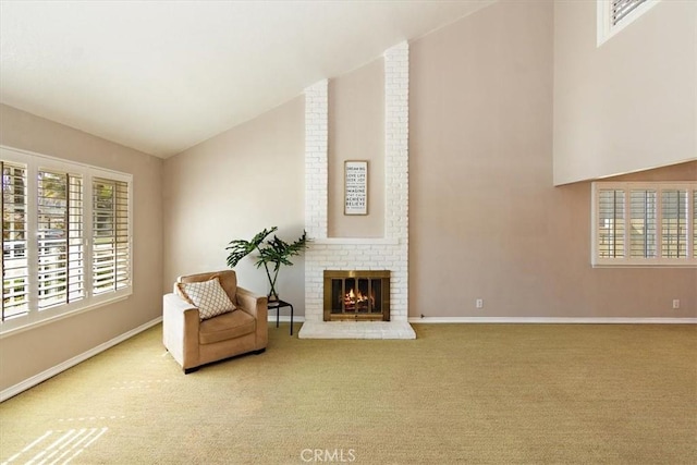 sitting room with baseboards, a fireplace, high vaulted ceiling, and carpet flooring