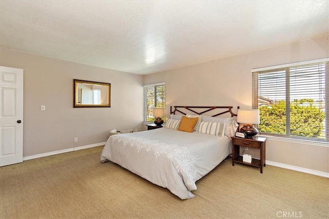 bedroom featuring baseboards and light colored carpet