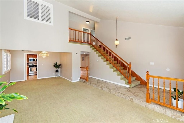 unfurnished living room featuring stairs, carpet, visible vents, and baseboards