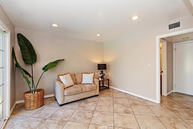 sitting room with light tile patterned floors, recessed lighting, visible vents, and baseboards