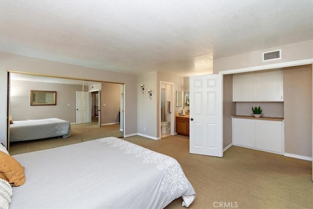 bedroom featuring light carpet, connected bathroom, visible vents, and baseboards