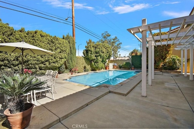 outdoor pool featuring a patio area, a fenced backyard, and a pergola