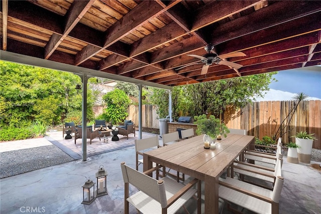 view of patio / terrace with outdoor dining space, area for grilling, a fenced backyard, and a ceiling fan