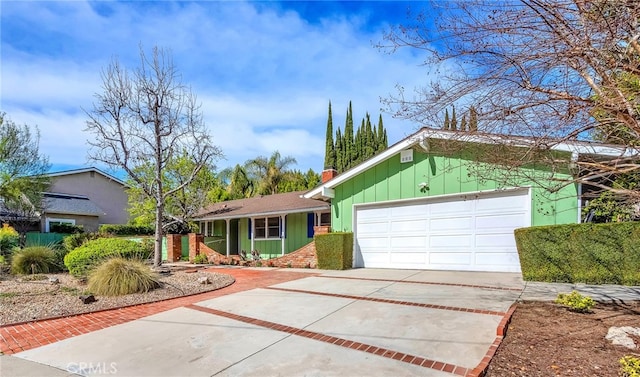 view of front facade featuring a garage, concrete driveway, and board and batten siding