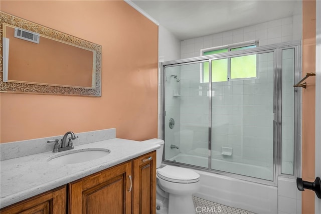 full bath with visible vents, toilet, tile patterned floors, combined bath / shower with glass door, and vanity