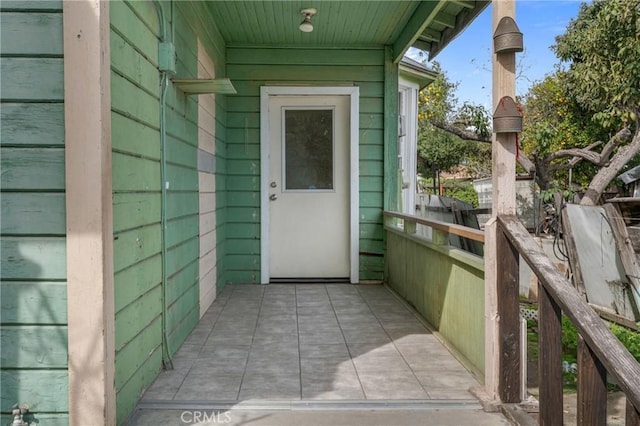 entrance to property featuring fence