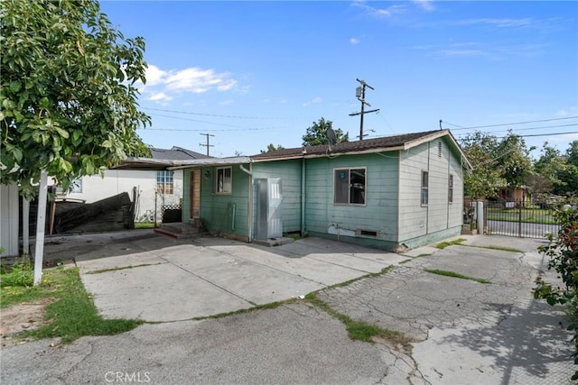 view of front of home featuring fence and a patio