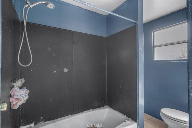 full bathroom featuring tile patterned flooring, toilet, and shower / bathtub combination