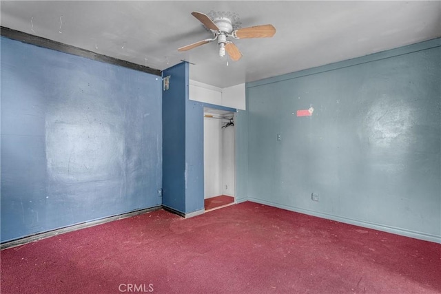 empty room featuring carpet floors and a ceiling fan