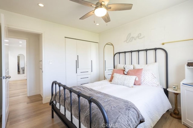 bedroom with light wood-style flooring, a closet, and recessed lighting