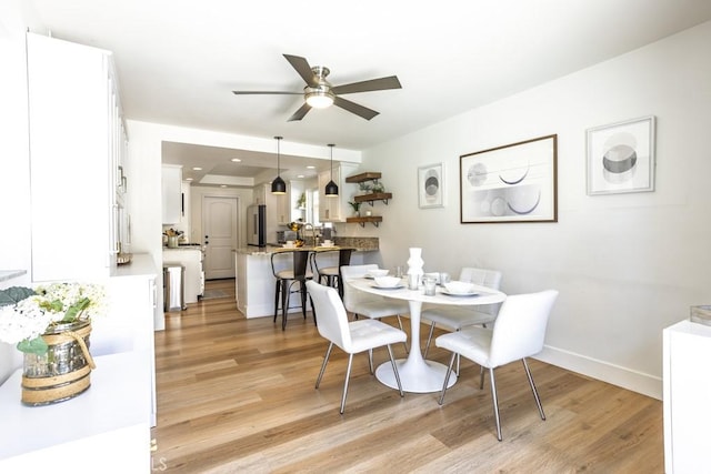 dining area with light wood-type flooring, baseboards, a ceiling fan, and recessed lighting