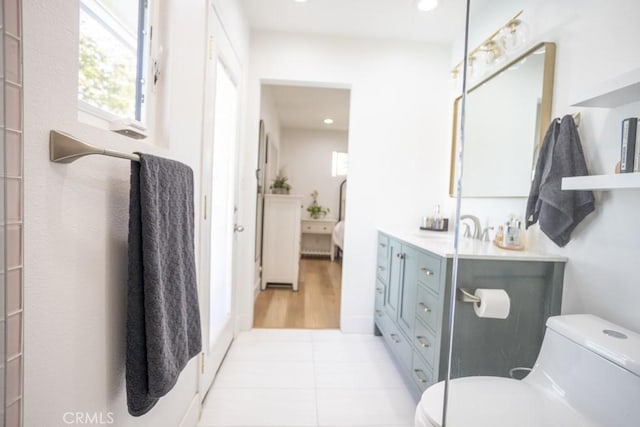 ensuite bathroom with toilet, ensuite bathroom, tile patterned flooring, vanity, and recessed lighting