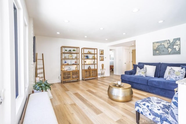 living area featuring light wood-type flooring, baseboards, and recessed lighting