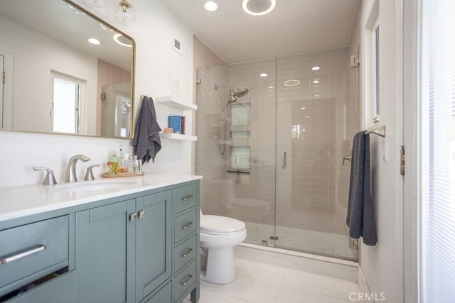 full bathroom featuring visible vents, toilet, a stall shower, vanity, and tile patterned flooring