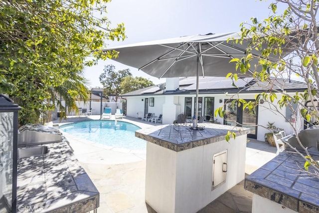 view of swimming pool with a patio area, fence, and a fenced in pool