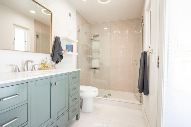 bathroom with toilet, a stall shower, tile patterned flooring, and vanity