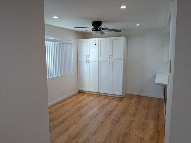 unfurnished bedroom featuring light wood-style floors, recessed lighting, a closet, and baseboards