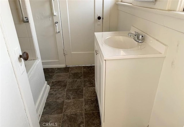 bathroom with a bathing tub and vanity