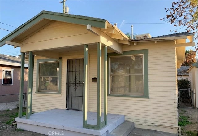 doorway to property featuring fence