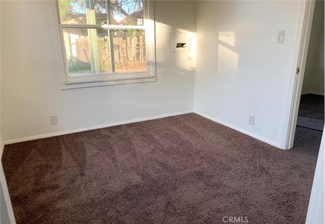 carpeted spare room with baseboards