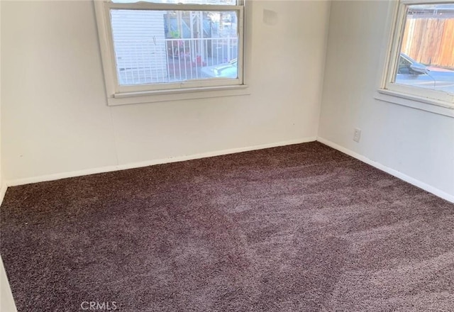 unfurnished room featuring carpet flooring and baseboards