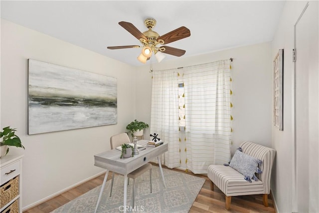 office featuring baseboards, a ceiling fan, and wood finished floors