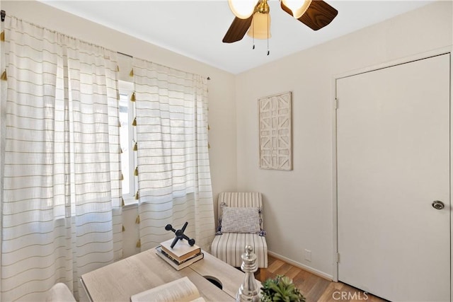 living area with ceiling fan and light wood-type flooring