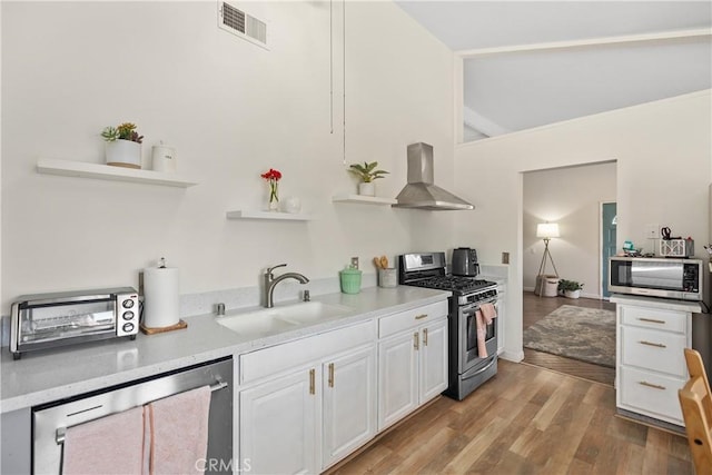 kitchen with open shelves, wall chimney exhaust hood, white cabinetry, and stainless steel appliances