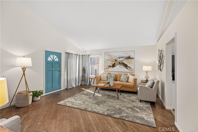 living room with dark wood-style floors, high vaulted ceiling, and baseboards