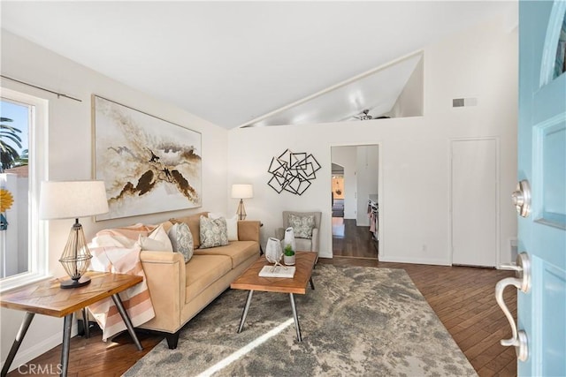 living area with lofted ceiling, dark wood-style floors, baseboards, and visible vents