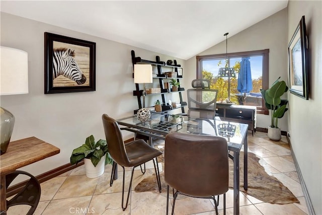 tiled dining area with vaulted ceiling, baseboards, and an inviting chandelier