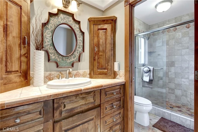 full bath with a shower stall, toilet, and vanity