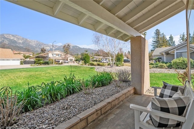 view of patio / terrace with a residential view and a mountain view