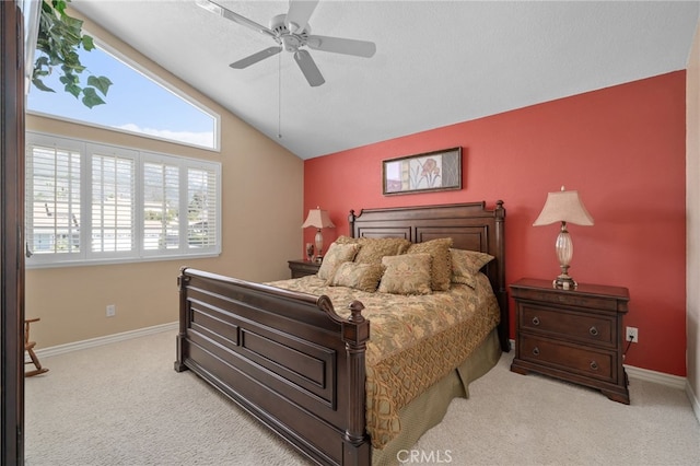 bedroom featuring light carpet, ceiling fan, baseboards, and vaulted ceiling