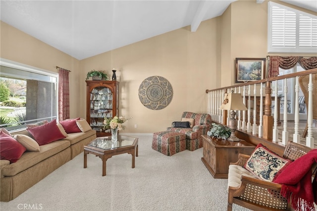 living area featuring high vaulted ceiling, beam ceiling, carpet flooring, and baseboards