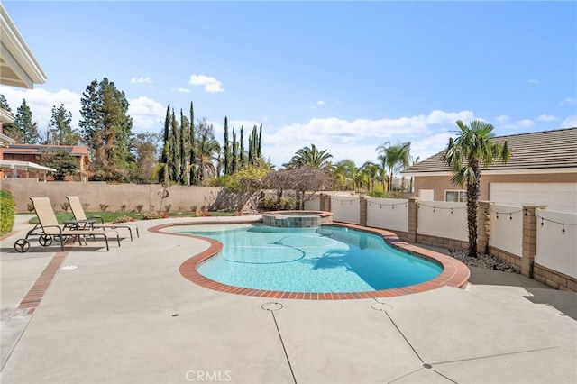 view of swimming pool with a pool with connected hot tub, a fenced backyard, and a patio